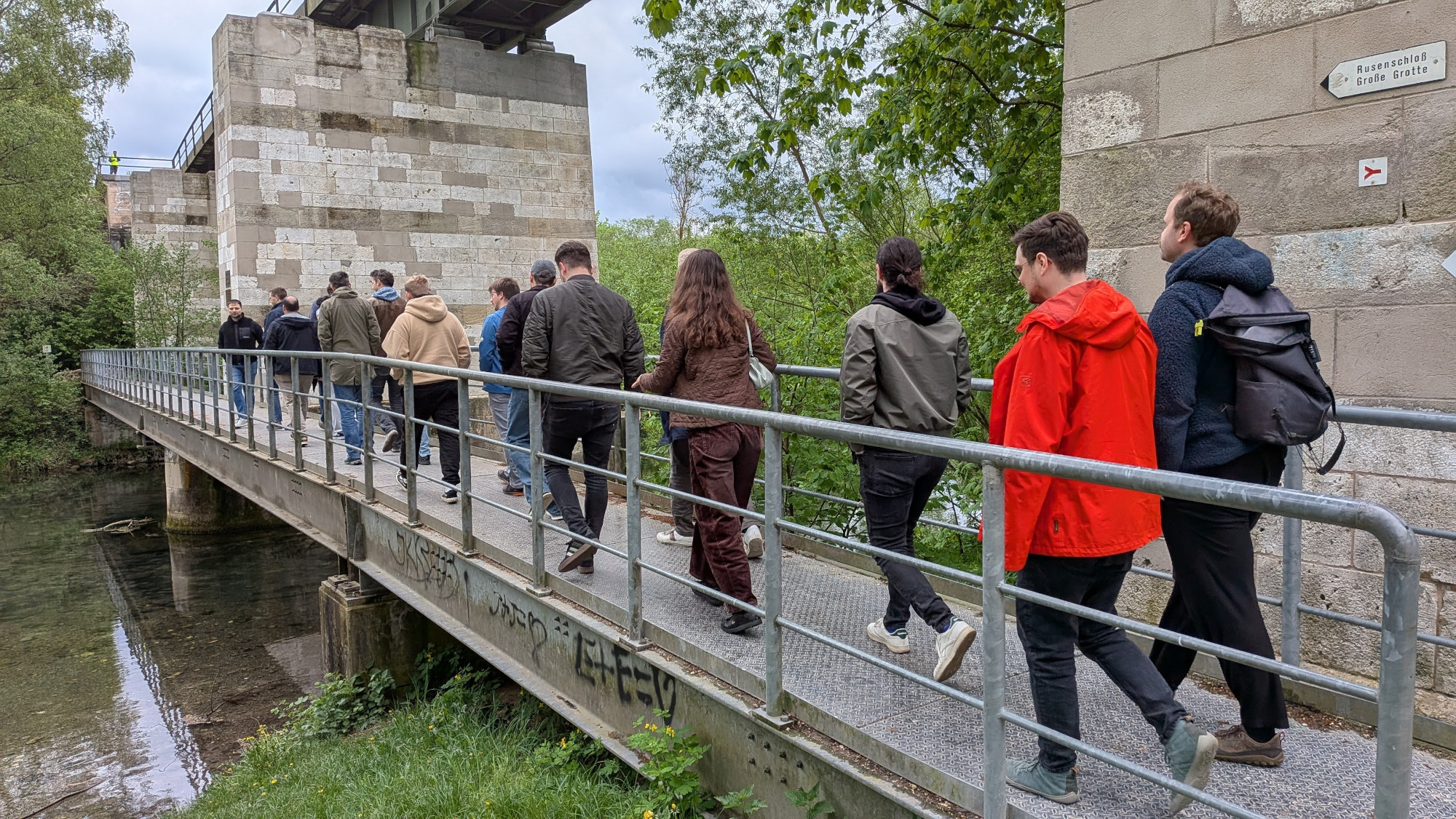 Attendees walking over a bridge
